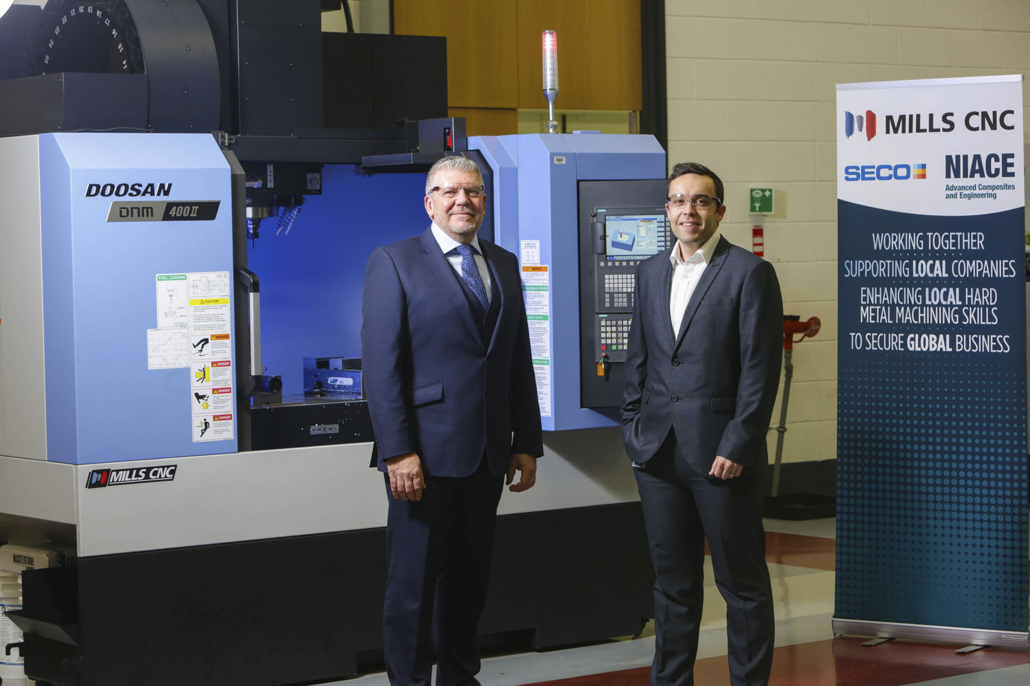 Dr Scott King, Manager at the NIACE Centre (right) with Mr Martin Blakely, Mills CNC’s Business Manager Ireland (left), in front of the Doosan DNM 400 II.