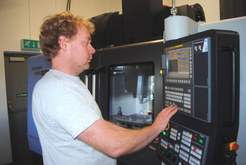 Mills CNC's Matt North working on machinery