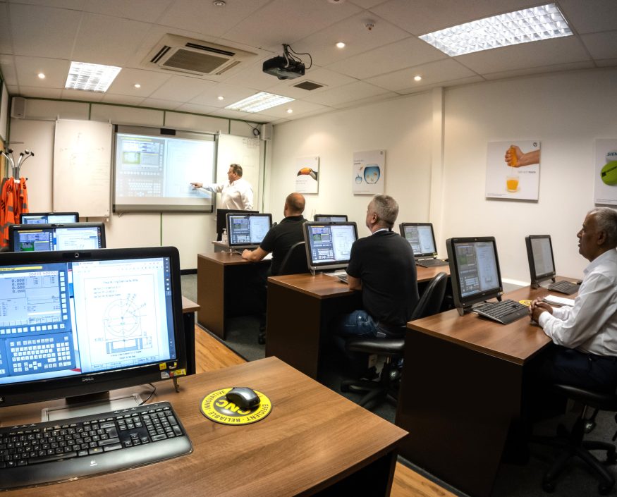 Trainees learning CNC skills