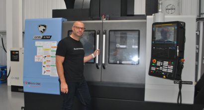 Operator standing by the doors of a DN Solutions DNM 5700 machining centre