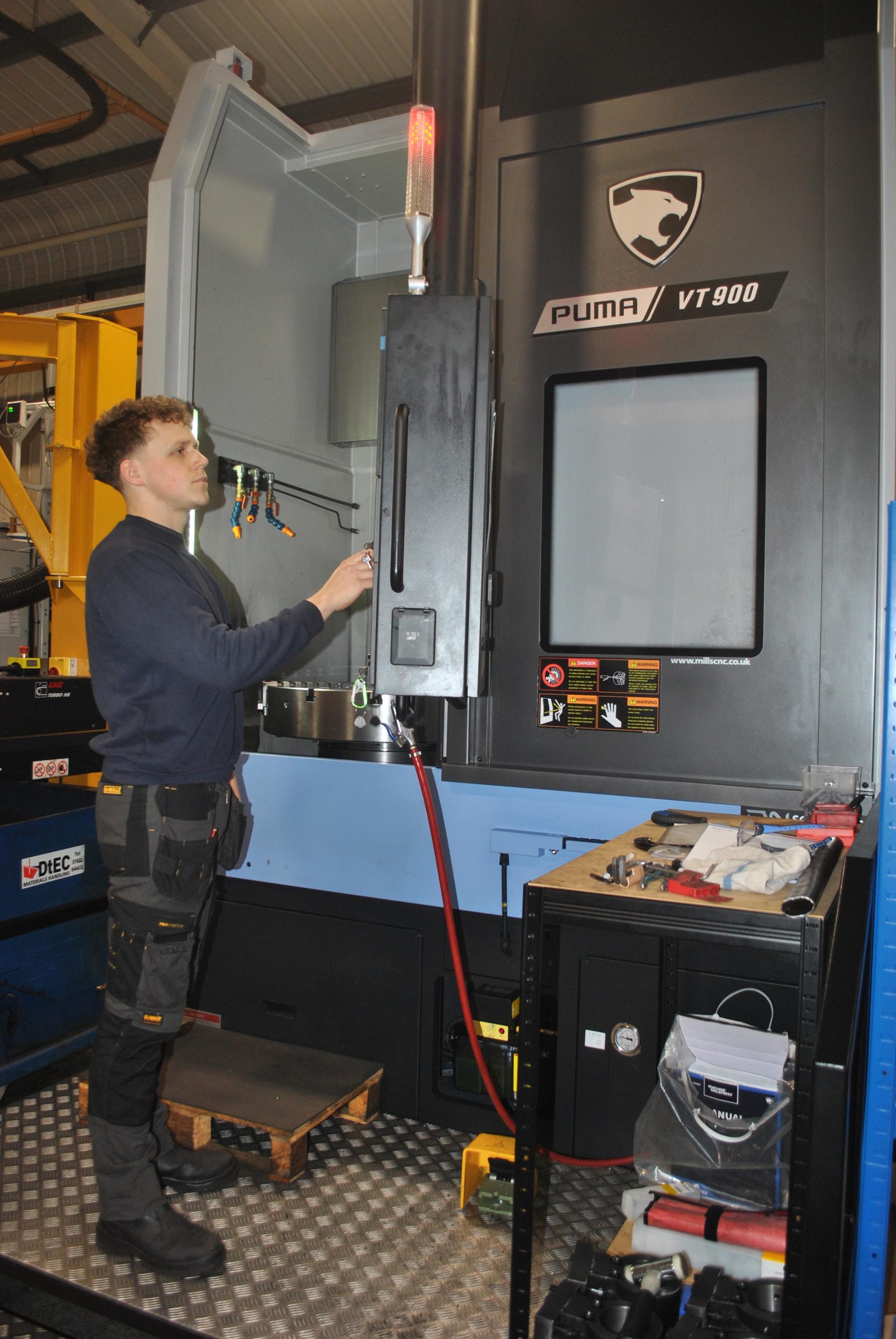Operator at the controls of a VT900 CNC machine