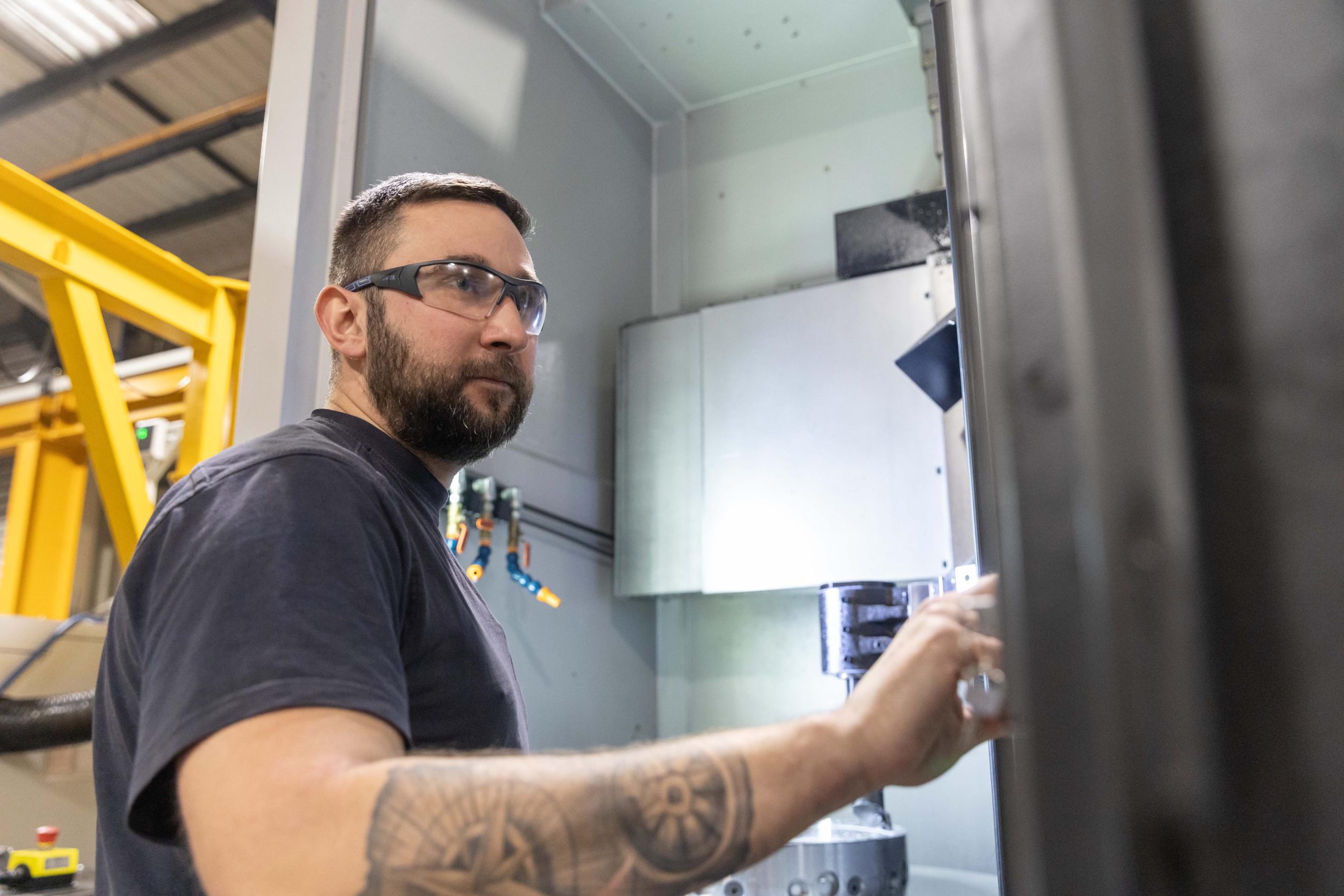 Operator opening the doors of a Puma VT900 vertical turning lathe