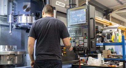 Operator working the controls of a VT900 vertical turning lathe