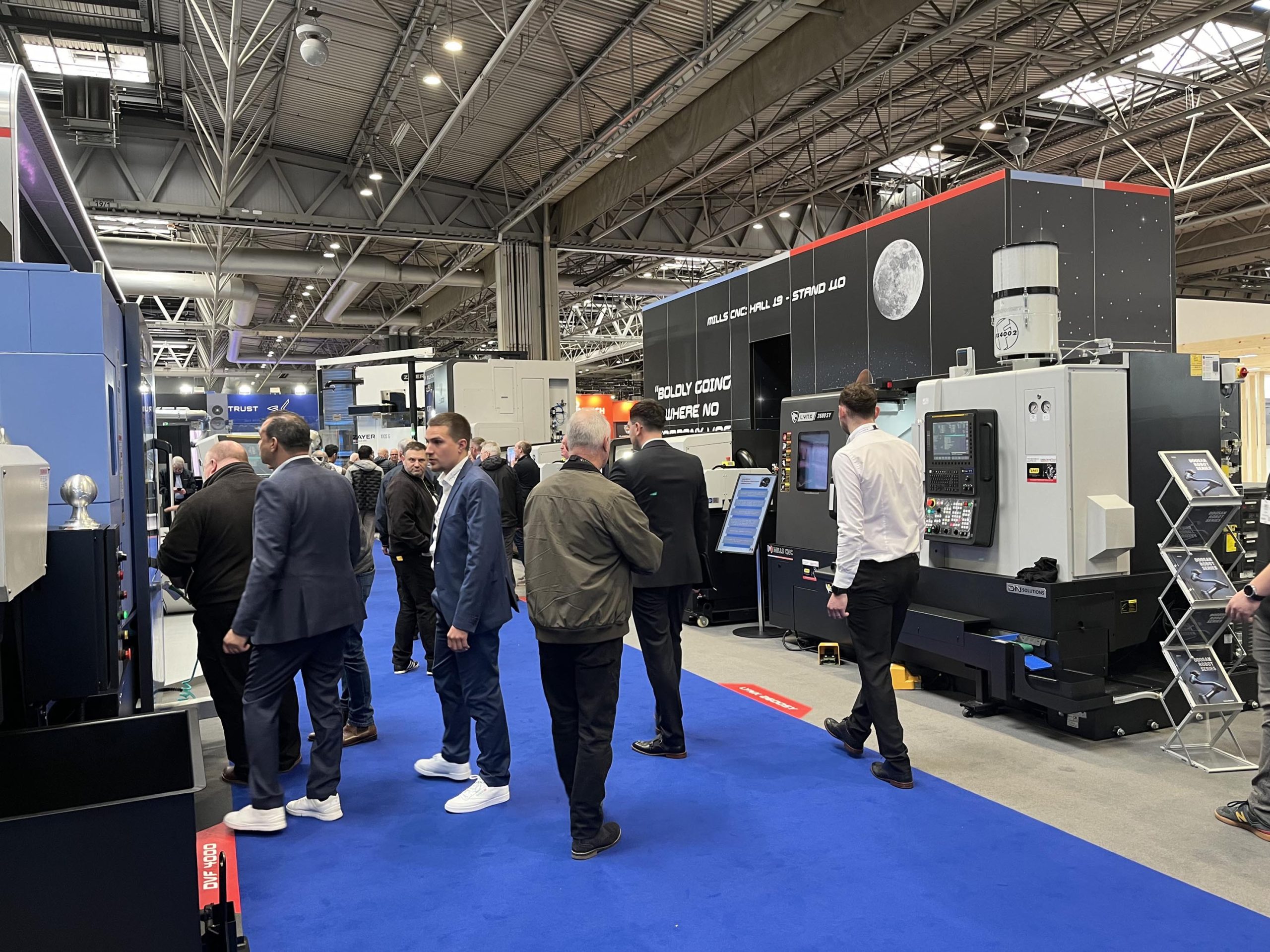 A crowd of people looking at the CNC machines exhibited at the Mills CNC stand at MACH 2024