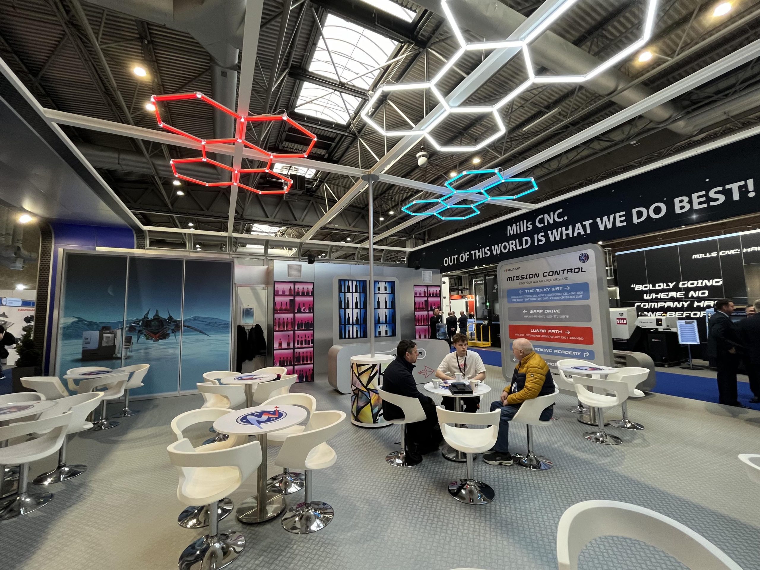 People enjoying a coffee at the Hospitality section of the Mills CNC stand at MACH 2024