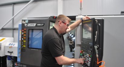 Operator at the controls of a Lynx 2100LSYB at Herriott Precision