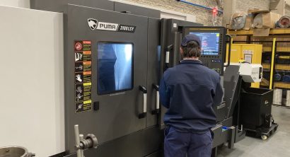 An operator at a DN Solutions Puma 3100LSY Horizontal Single Turret Lathe