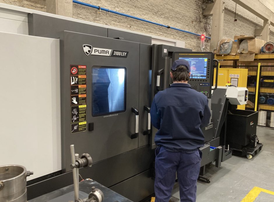 An operator at a DN Solutions Puma 3100LSY Horizontal Single Turret Lathe